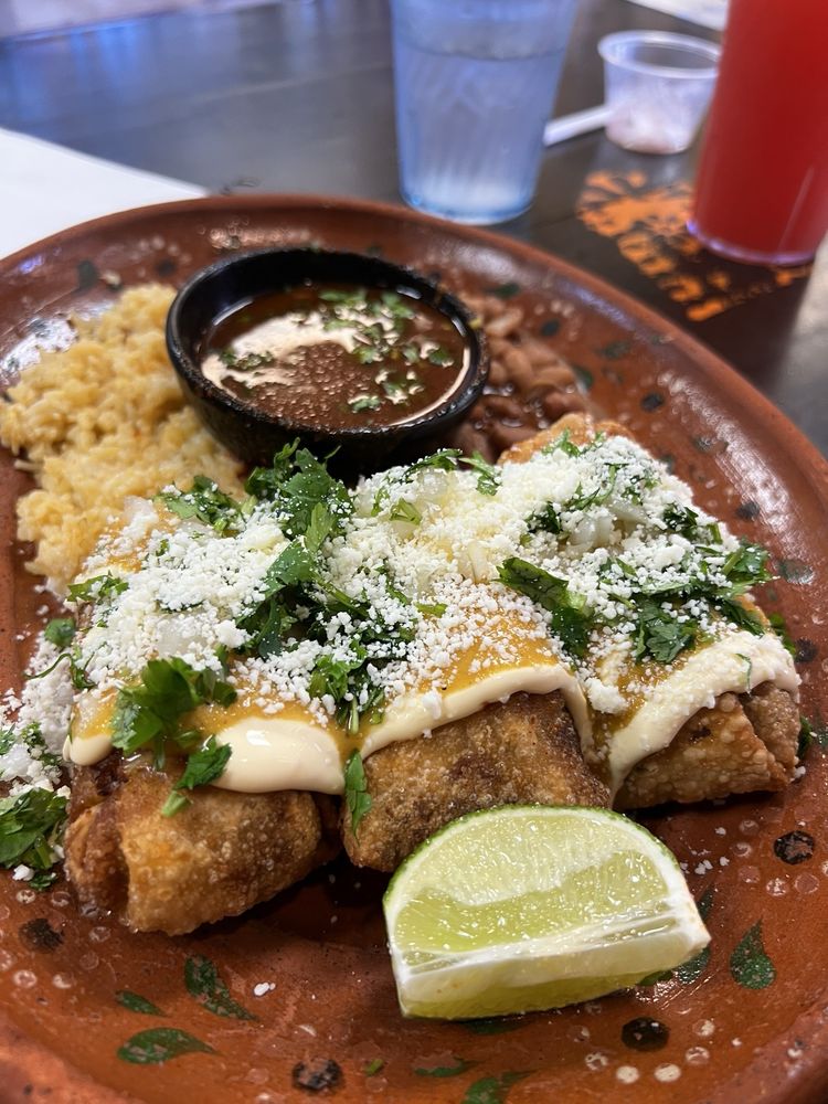 Birria eggrolls cut open with melted cheese