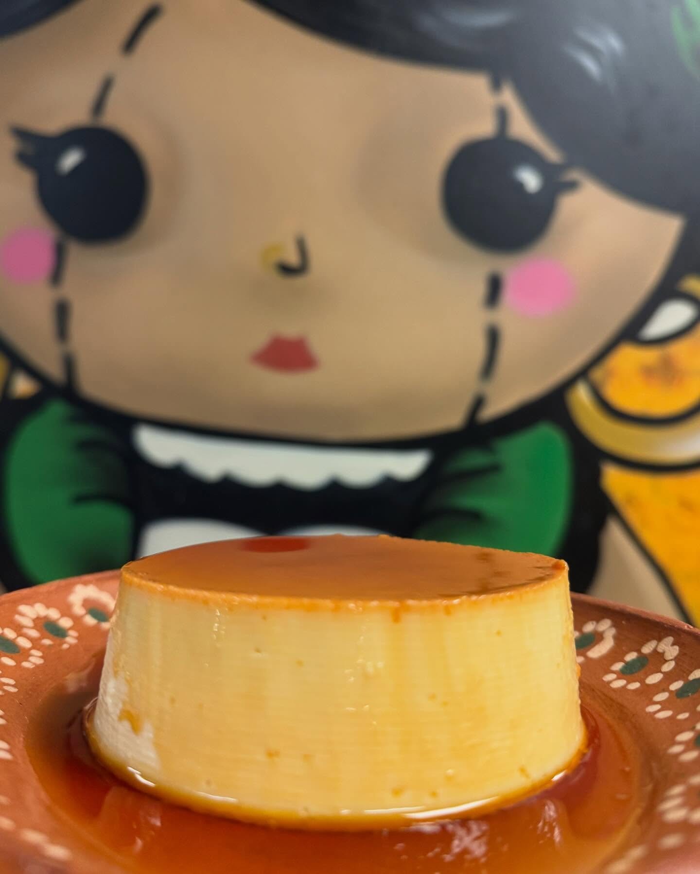 House flan in front of the painted muñeca mural