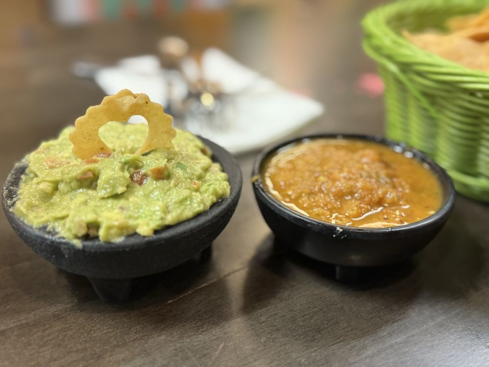 Guacamole and salsa served in stone molcajetes