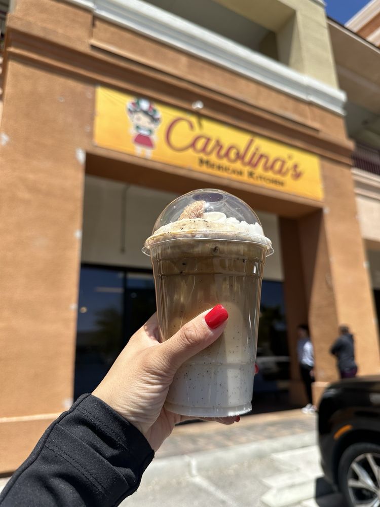 Horchata latte in front of the storefront sign