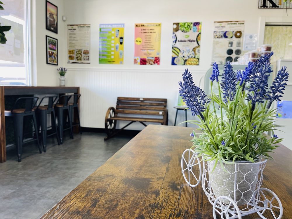 The bright, clean dining area with wooden tables and a lavender centerpiece
