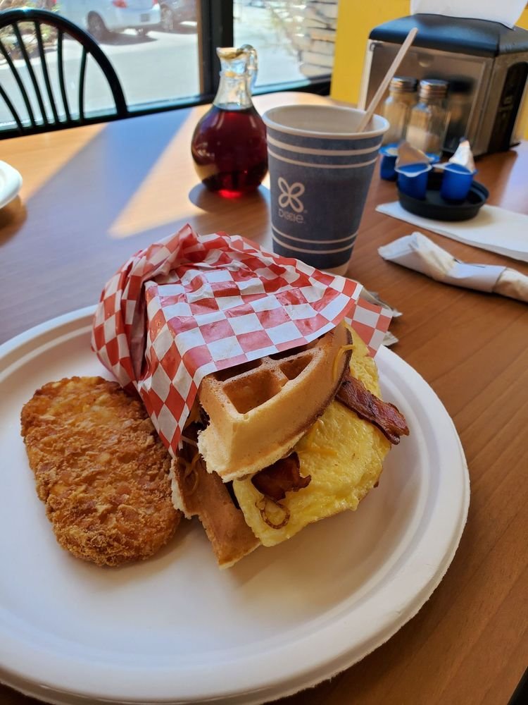 Breakfast waffle sandwich served with a golden hash brown